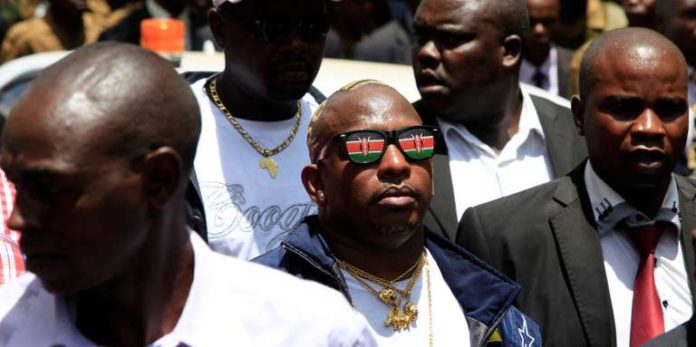 Nairobi Senator Mike Sonko dons sunglasses bearing the likeness of the Kenyan flag while welcoming Kenya's President Uhuru Kenyatta back from the Hague, in the capital Nairobi