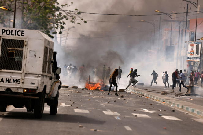Demonstrators clash with police during a protest of opposition groups in Dakar
